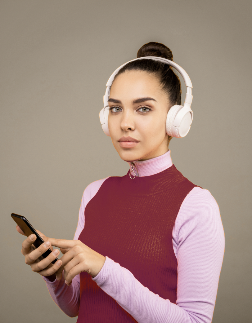 Portrait of female on phone wearing headphones