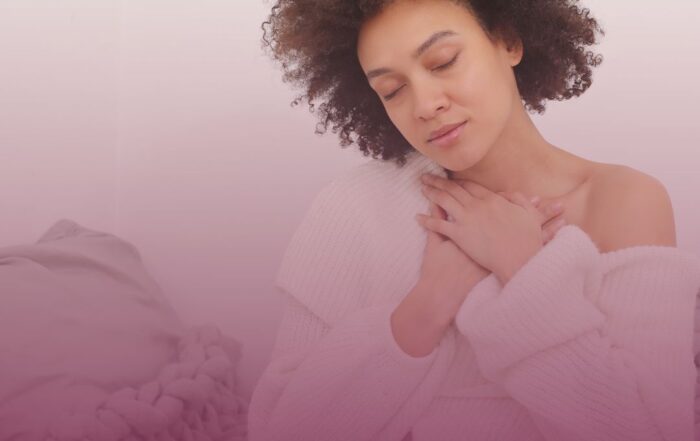 Black female meditating and practicing deep breathing exercises in her room