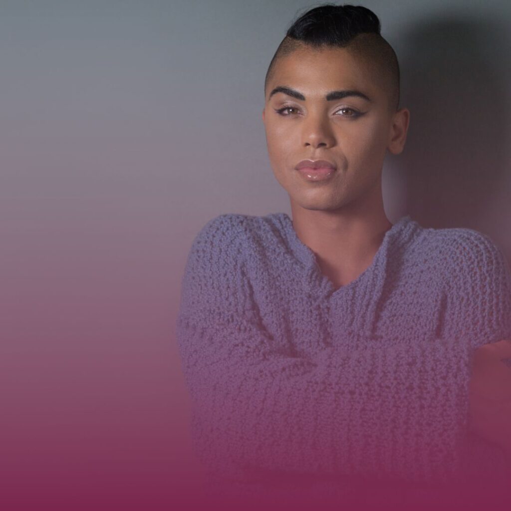 Gay Man in blue sweater with arms crossed over chest